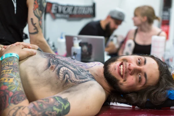 People make tattoos at Tattoo Convention — Stok fotoğraf