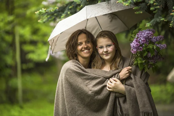 Woman with her daughter under umbrella Stock Fotó