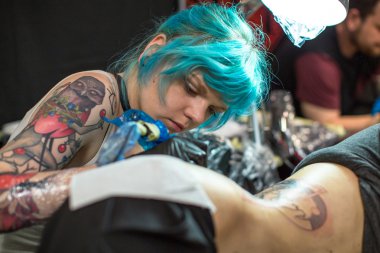 People make tattoos at Tattoo Convention