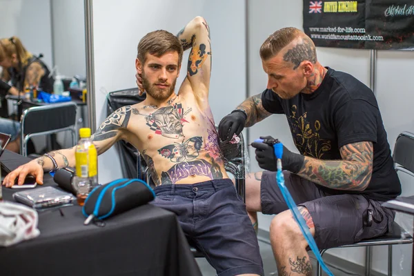 People make tattoos at Tattoo Convention — Zdjęcie stockowe