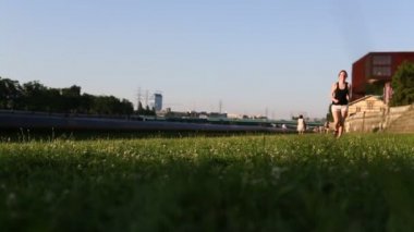 Young girl runs across grass