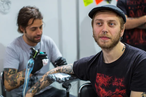 People make tattoos at Tattoo Convention — Stok fotoğraf