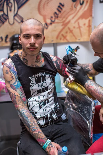 As pessoas fazem tatuagens na Convenção de Tatuagem — Fotografia de Stock
