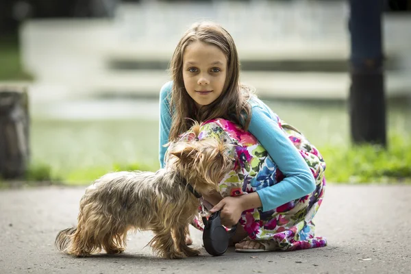 Menina em uma caminhada com pouco cão . — Fotografia de Stock