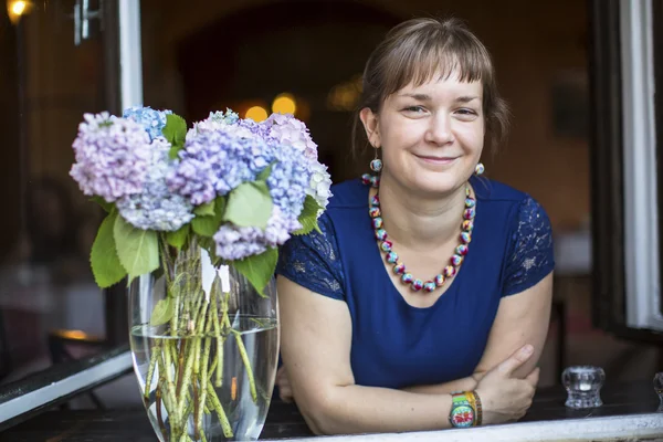 Junge Frau schaut aus dem Fenster — Stockfoto