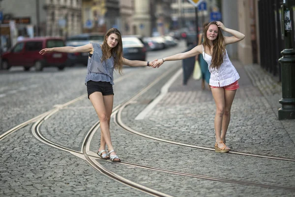 Girlfriends walk along tram tracks — Stock Photo, Image
