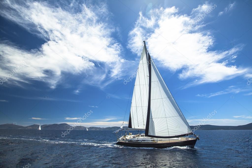 Sailing yachts with white sails