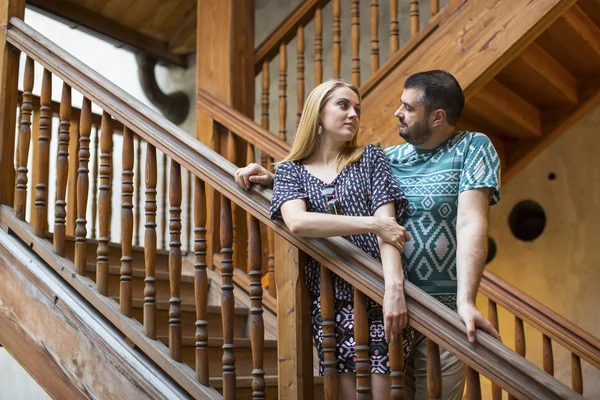 Couple in love standing on wooden staircase — Stock Photo, Image