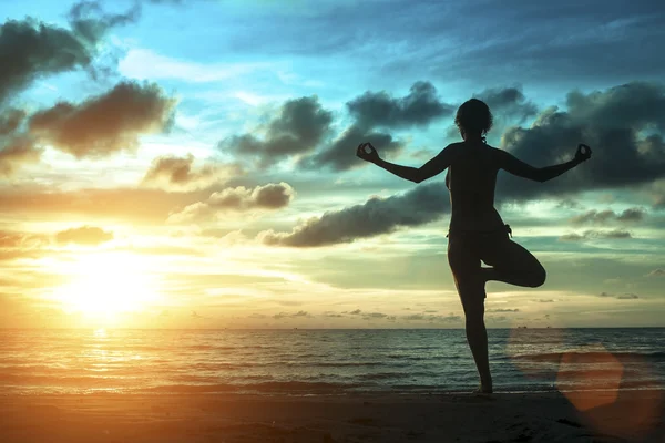 Silhouette of woman standing at yoga pose — Stock Photo, Image
