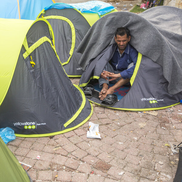 Unidentified war refugee near the tents
