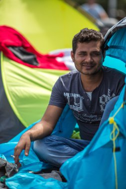 Unidentified refugee near tents