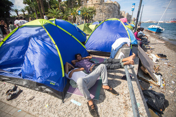 Unidentified war refugees near tents