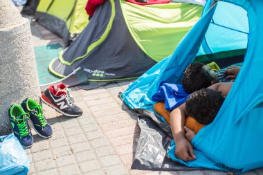 Unidentified refugees sleep in tents