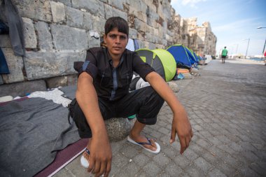 Unidentified refugee near tents