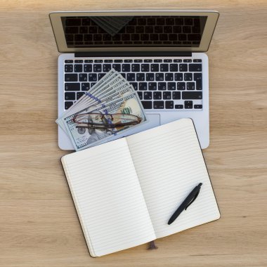 Laptop, dollars and  bills