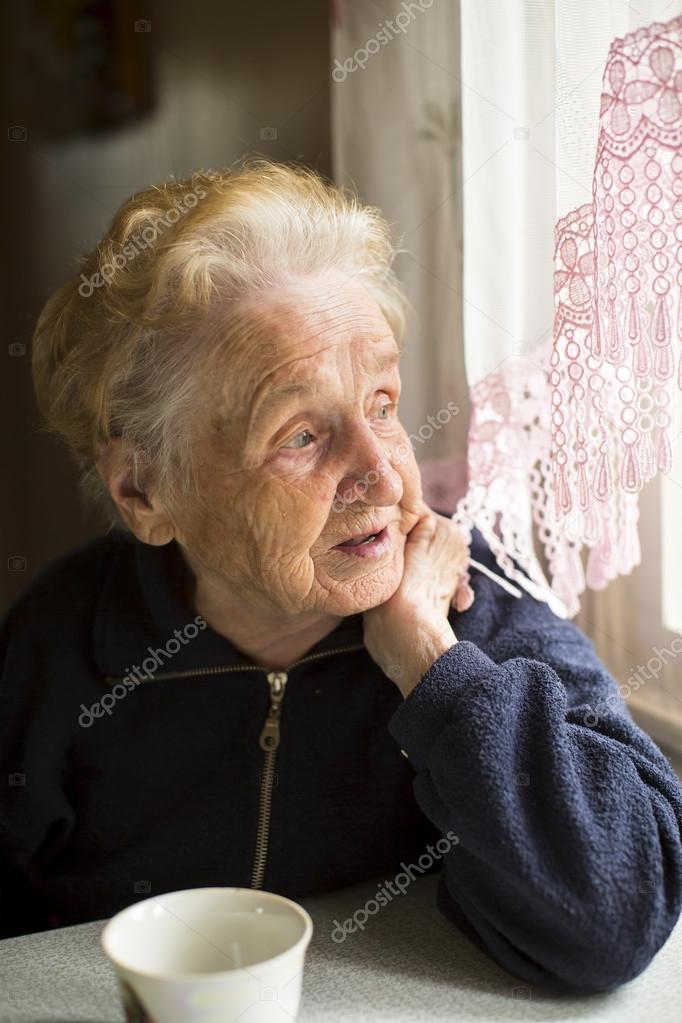 elderly lady sitting near the window