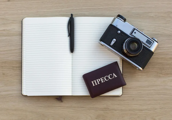 Notepad with pen, film camera and Russian Press ID — Stock fotografie