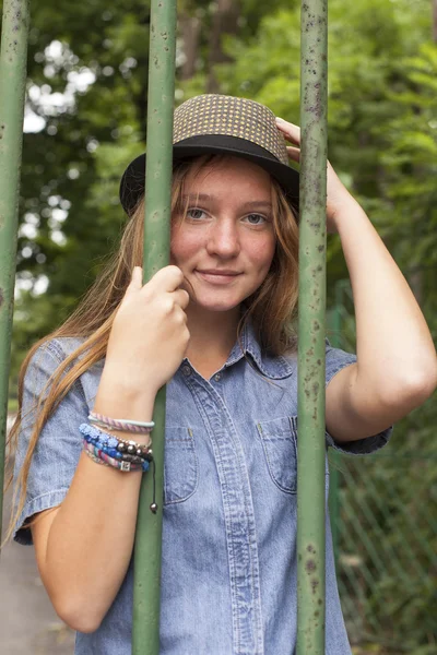 Young girl behind fence — Stock Photo, Image