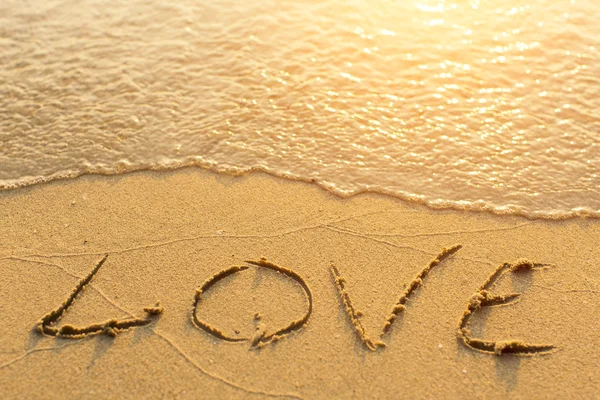 Inscription LOVE on sea beach — Stock Photo, Image