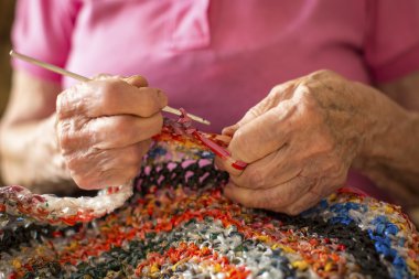 elderly woman kniting crochet.