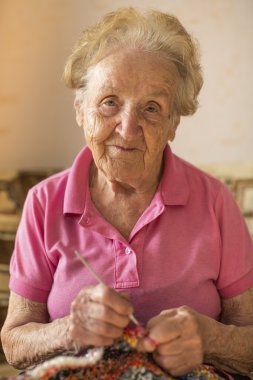 elderly woman kniting crochet.