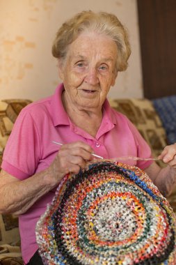 elderly woman kniting crochet.