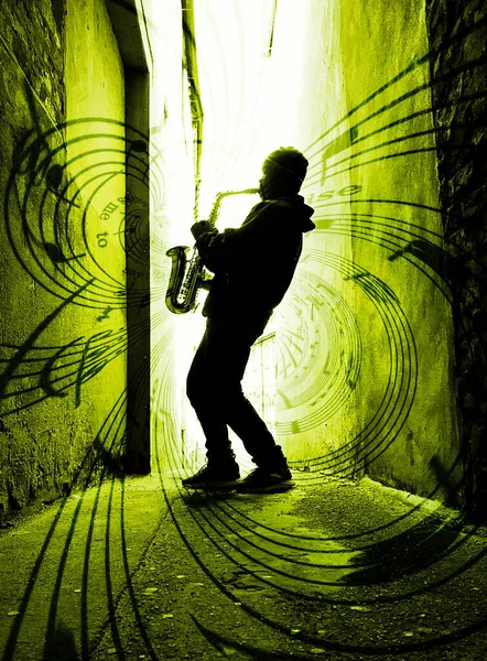 street sax player silhouetted against yellow light with music pouring from the sax
