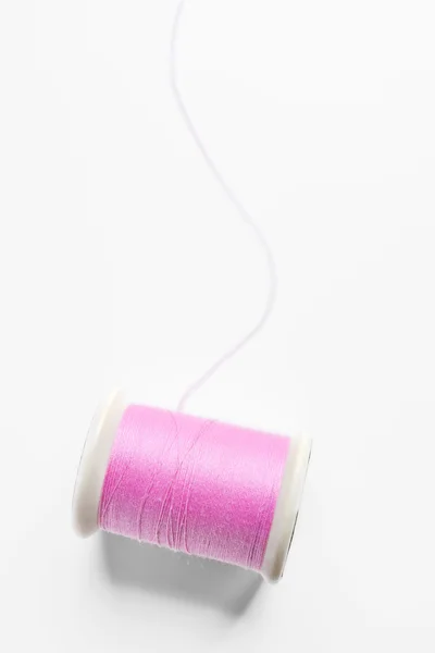Pink thread on white background — Stock Photo, Image
