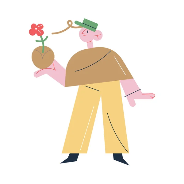 Człowiek ogrodnik stojący i trzymający kwiat w ziemi w ręku podczas ogrodnictwa — Wektor stockowy