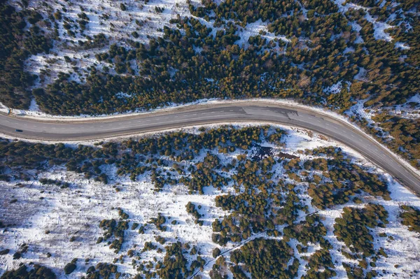 Aerial view on mountain road from drone in winter