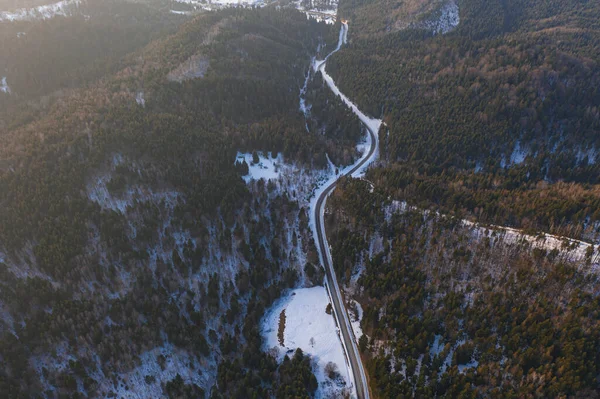 Aerial view on mountain road from drone in winter