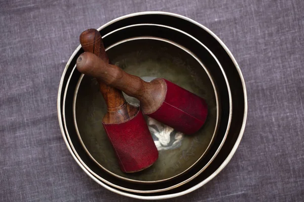 Singing bowls for massage on grey background