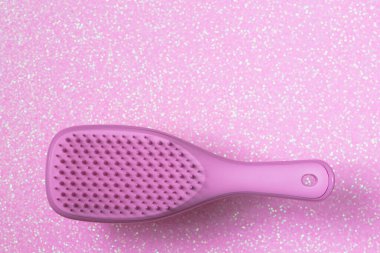 Pembe arka planda izole edilmiş pembe saç fırçası