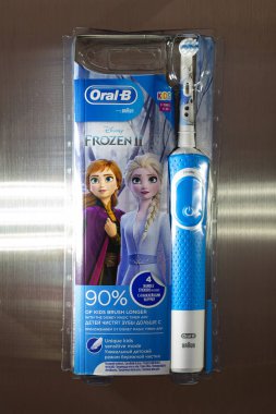 Frankfurt, Germany - April 10, 2021: Braun Oral-B rechargeable toothbrush for kids 3+ years. Disney Frozen II clipart