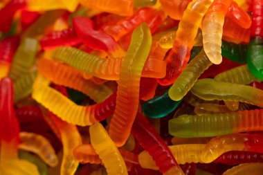 Çok renkli jöle solucanı şekerlemeleri desenli arka plan