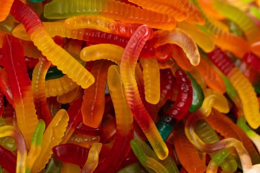 Çok renkli jöle solucanı şekerlemeleri desenli arka plan