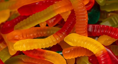 Çok renkli jöle solucanı şekerlemeleri desenli arka plan