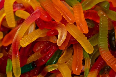 Çok renkli jöle solucanı şekerlemeleri desenli arka plan