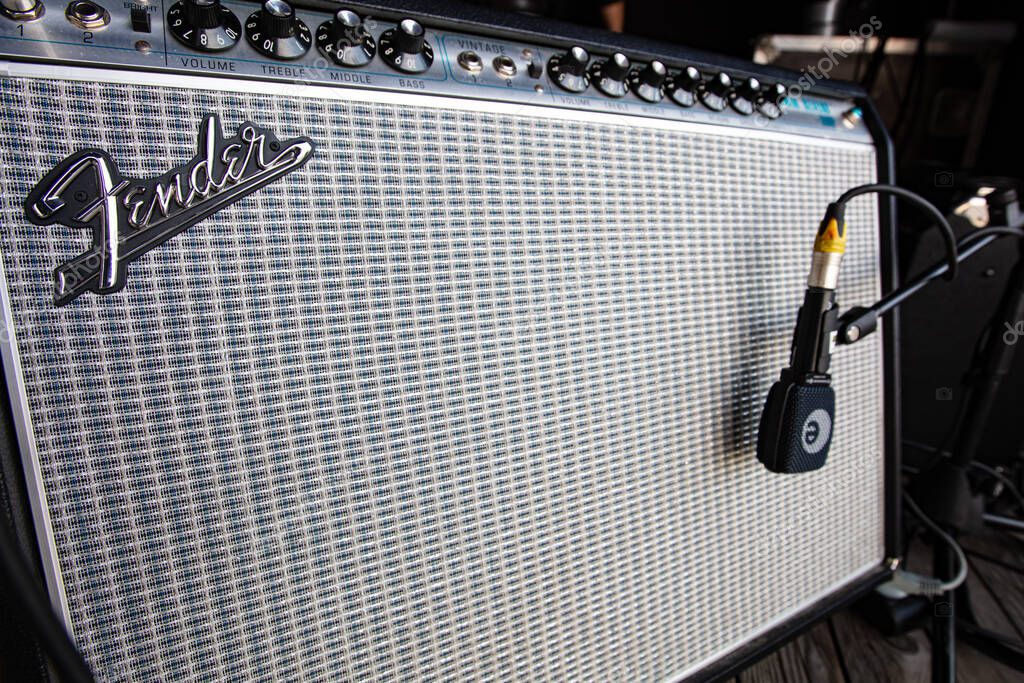 Lviv, Ukraine - May 20, 2021: Fender amplifier on concert stage and Sennheiser e 906 Instrument Microphone