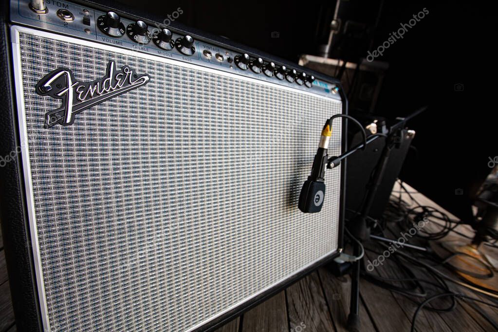 Lviv, Ukraine - May 20, 2021: Fender amplifier on concert stage and Sennheiser e 906 Instrument Microphone