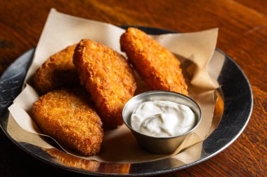 Crispy Fried Cheese Sticks or Hash Browns with White Dipping Sauce