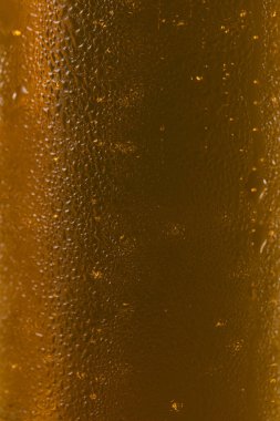 Extreme Close-up of Cold Golden Beer Foam and Condensation