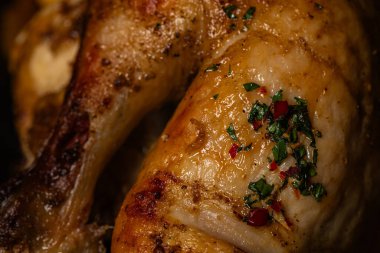 Close-up of Golden Roasted Chicken with Glossy Skin and Chili Garnish