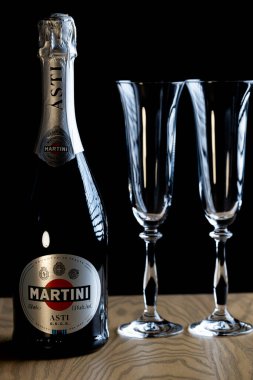 Lviv, Ukrayna - 4 Kasım 2025: Martini Asti köpüklü şarap şişesi ve iki kristal bardak