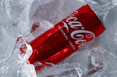 Lviv, Ukraine - February 6, 2026: Red Coca-Cola Soda Can in Ice