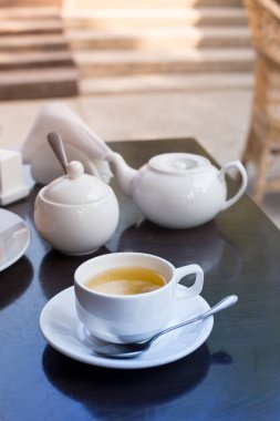 Kafedeki masanın üstünde bir fincan çay var..