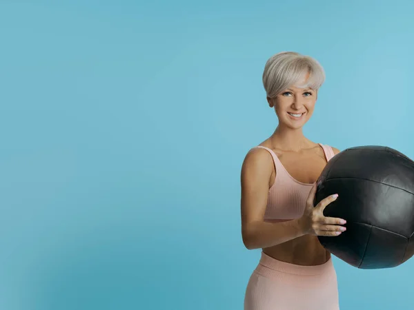 漂亮性感的女运动员拿着医疗球。复制SPACE — 图库照片