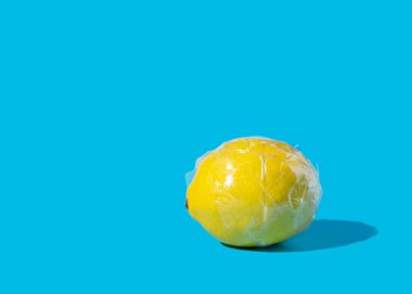 Açık plastik bantla sarılmış sarı limon