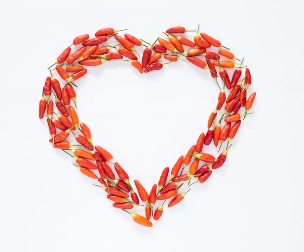 Love is spicy in flatlay chili pepper heart Stock Image