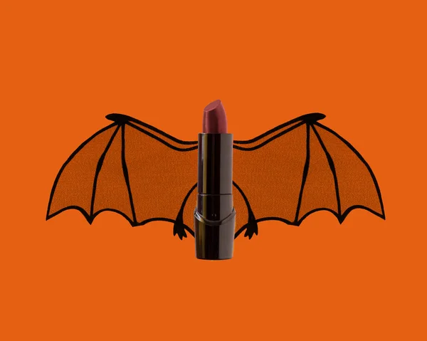 Dunkelroter Lippenstift Mit Fledermausflügeln Auf Orangefarbenem Hintergrund Für Gruselige Beauty — Stockfoto